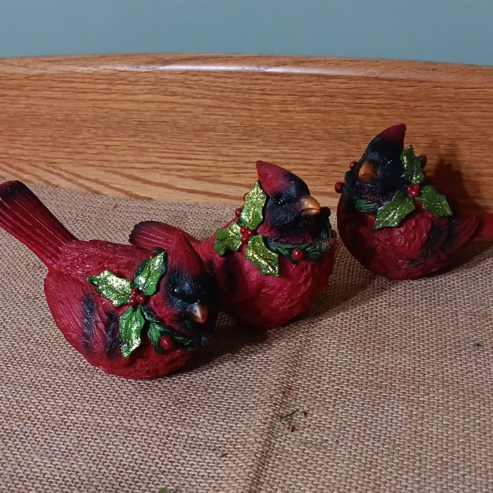 Three holly Cardinals
